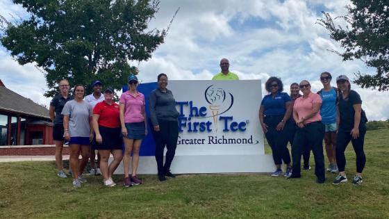 Women standing in front of sign
